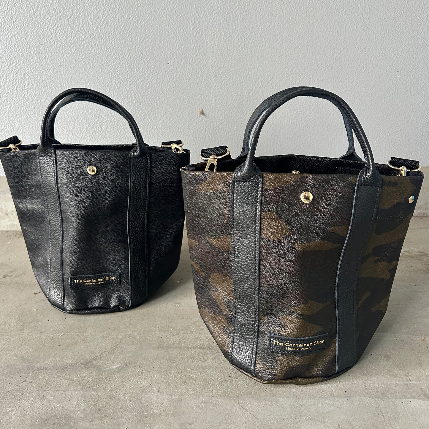 "Lightweight and wipeable" PVC-coated (round-bottom tote) in dark camouflage