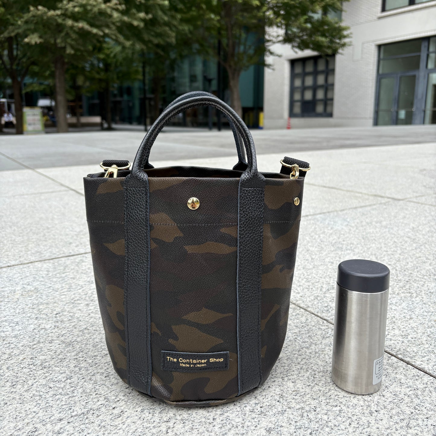 "Lightweight and wipeable" PVC processed (round bottom tote) in black camouflage