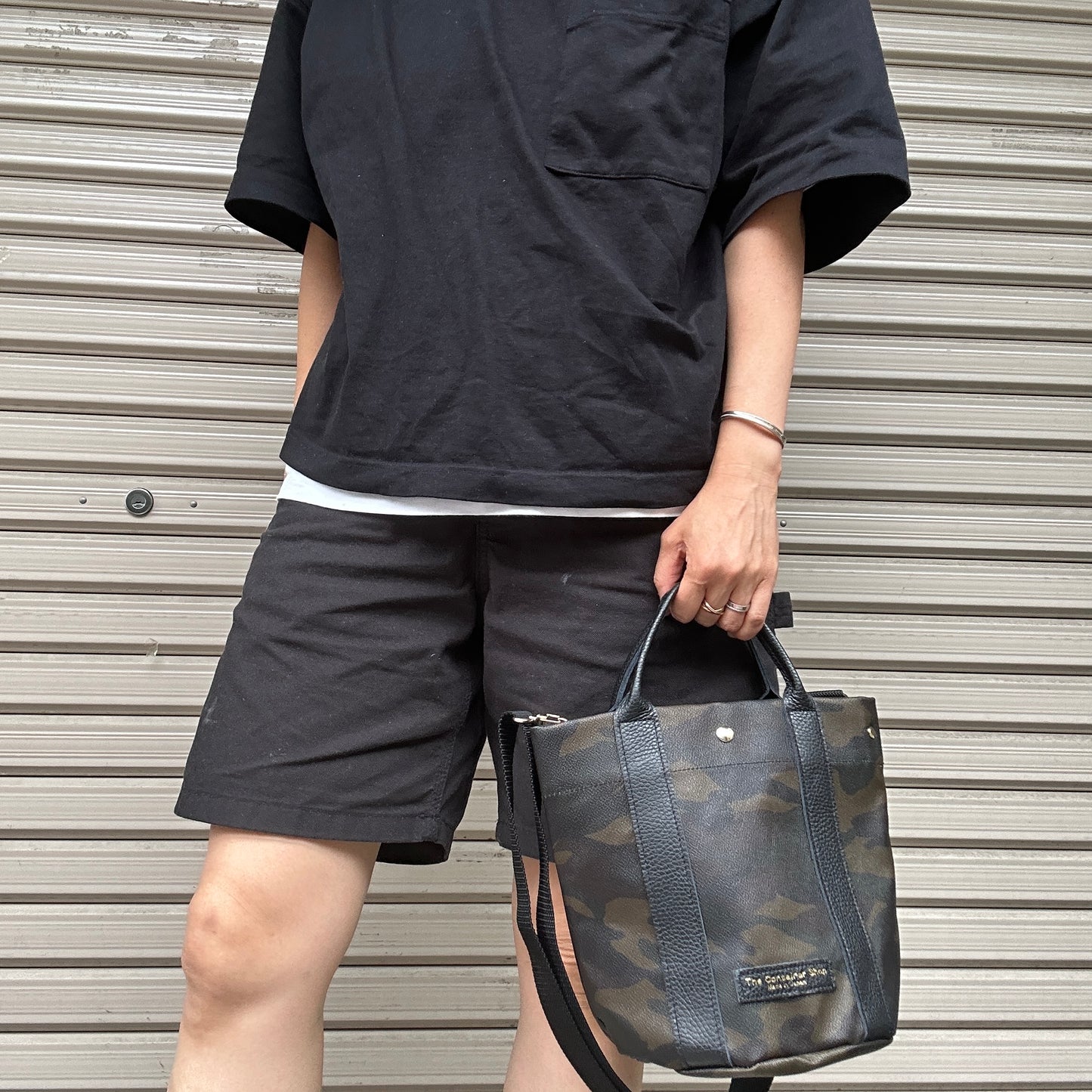 "Lightweight and wipeable" PVC-coated (round-bottom tote) in dark camouflage