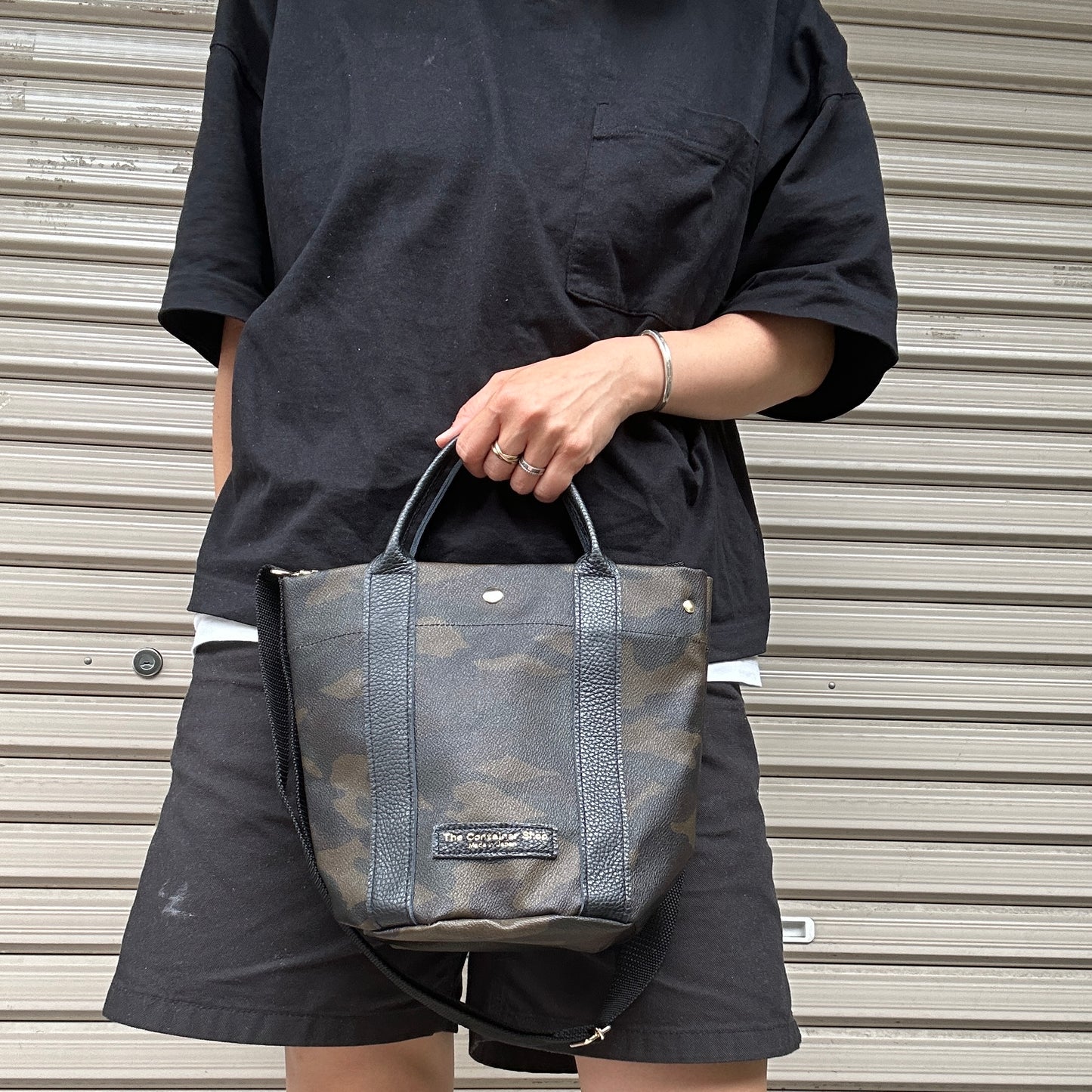 "Lightweight and wipeable" PVC-coated (round-bottom tote) in dark camouflage