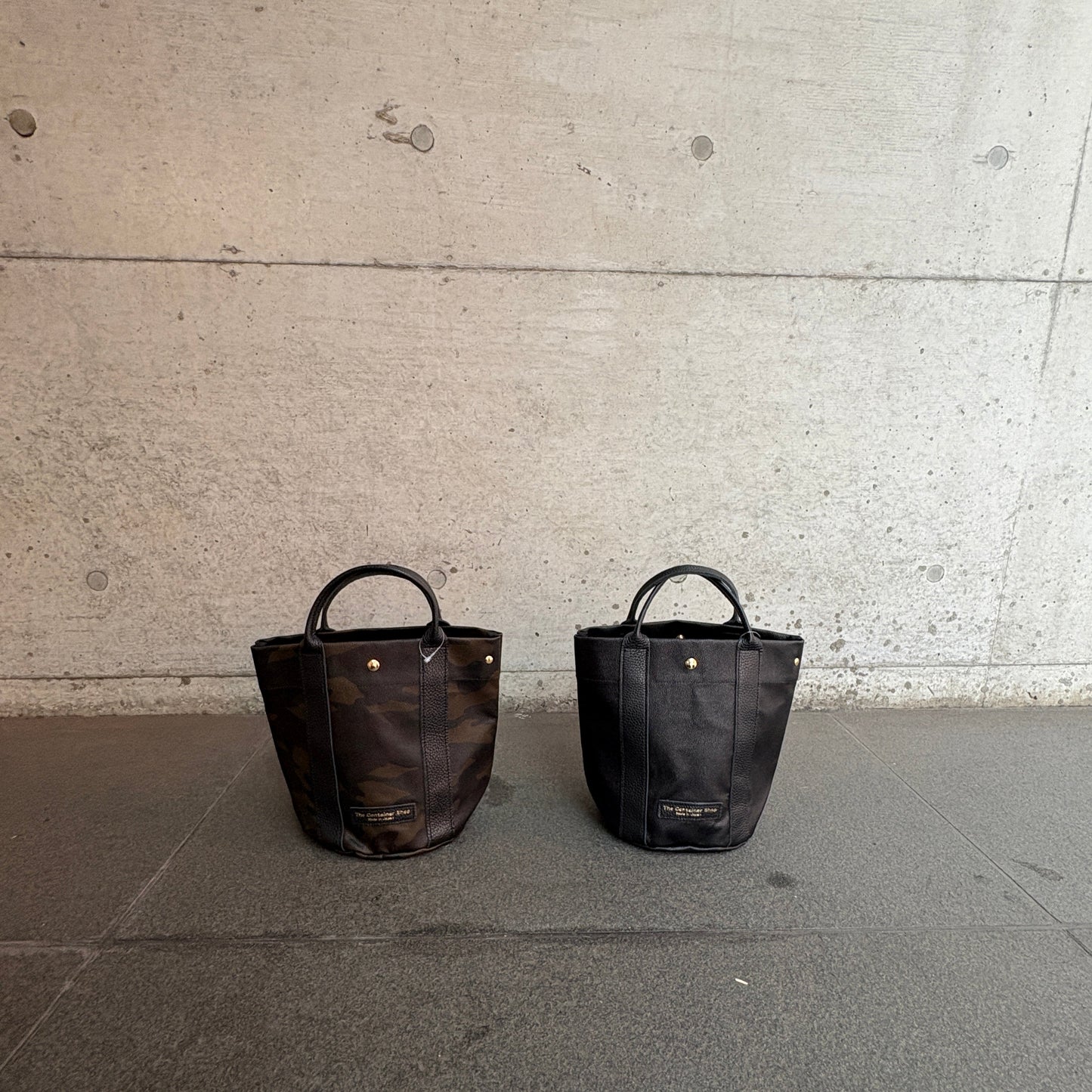 "Lightweight and wipeable" PVC processed (round bottom tote) in black camouflage