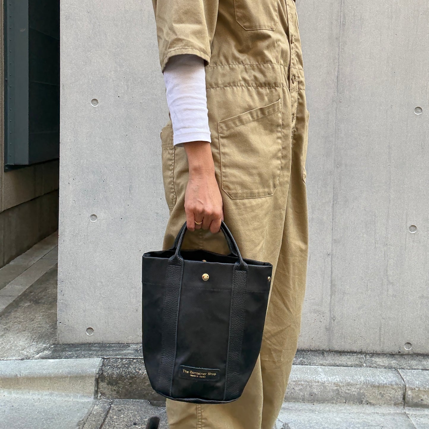 "Lightweight and wipeable" PVC processed (round bottom tote) in black camouflage