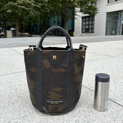 "Lightweight and wipeable" PVC processed (round bottom tote) in black camouflage