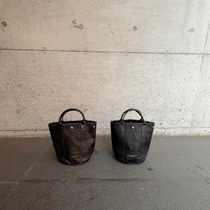 "Lightweight and wipeable" PVC processed (round bottom tote) in black camouflage