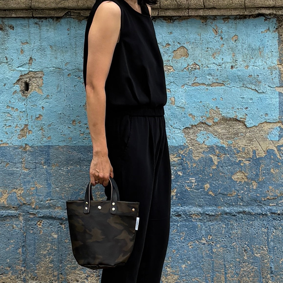  "Lightweight and wipeable" PVC-coated (round-bottom tote) in dark camouflage