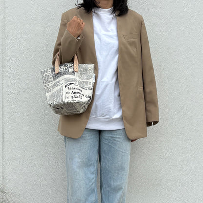 「軽くて拭ける」Coated PVC（丸底バッグ）Newspaper