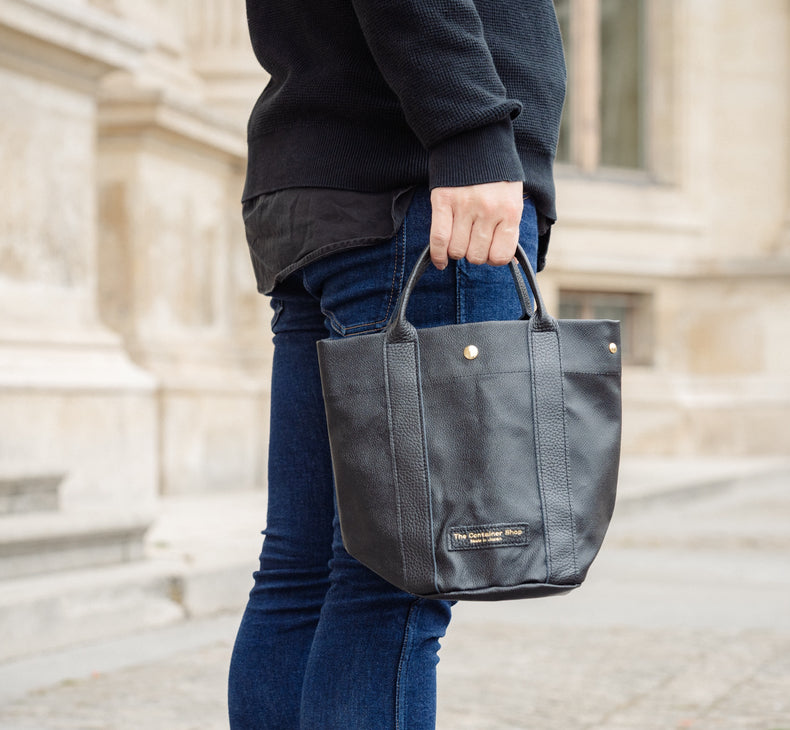 "Lightweight and wipeable" PVC processed (round bottom tote) in black camouflage