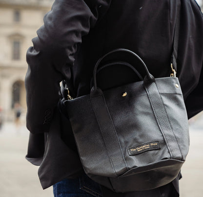 "Lightweight and wipeable" PVC processed (round bottom tote) in black camouflage