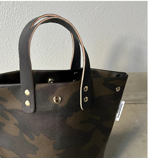  "Lightweight and wipeable" PVC-coated (round-bottom tote) in dark camouflage